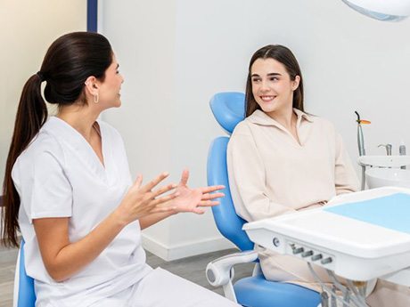 Patient and dental team member engaged in conversation