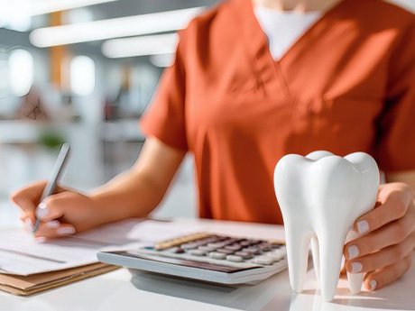 Dental team member standing behind desk