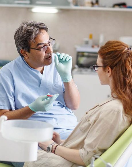 A dentist talking to his patient about cosmetic dental bonding