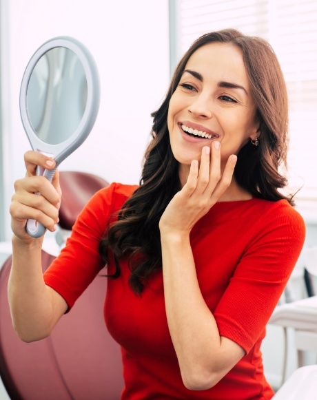 Woman with dental veneers looking at smile