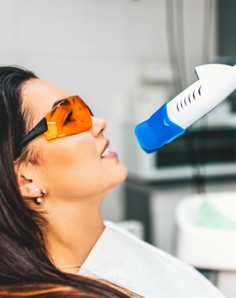 Woman receiving professional teeth whitening