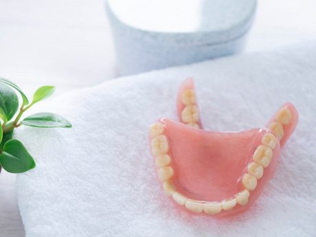 a pair of dentures lying on a towel