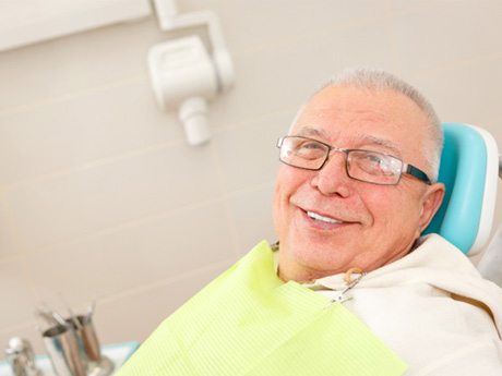 Dental team member and patient discussing the cost of dental emergencies