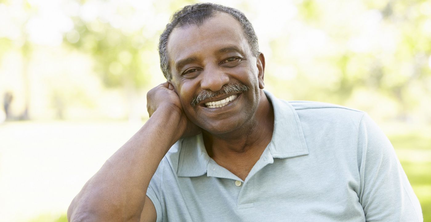 man smiling outdoors with dental implants in Huntsville