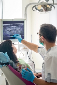 Dentist and dental patient looking at digital x-rays