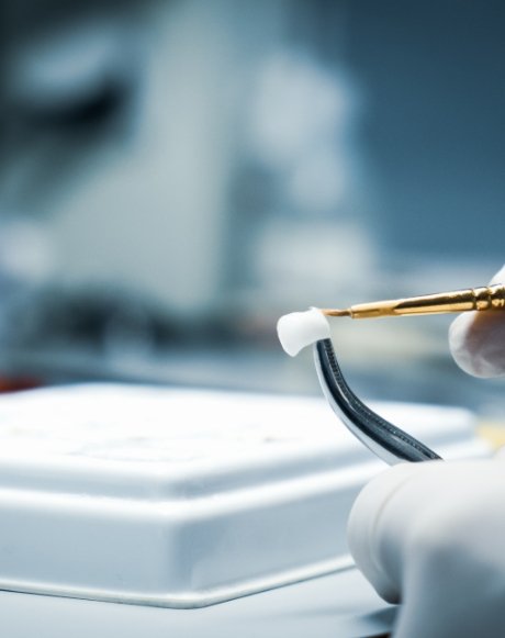 Dental lab technician crafting dental crowns