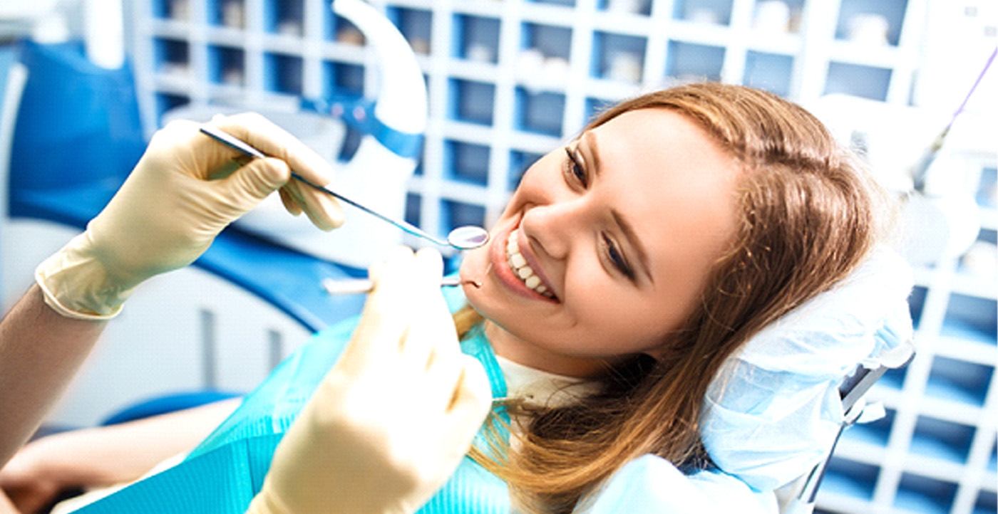 A smiling woman receiving a dental procedure